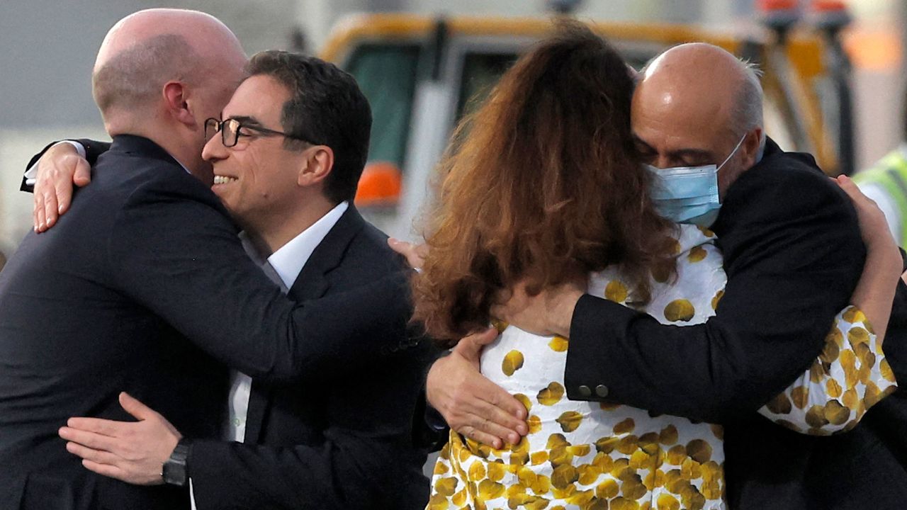 US citizens Siamak Namazi, second from left, and Morad Tahbaz, right, are embraced after disembarking from a jet in Doha, Qatar, on Monday, September 18. 
